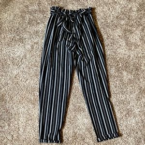 Black and white striped dress pants with a tie at the top. in great condition